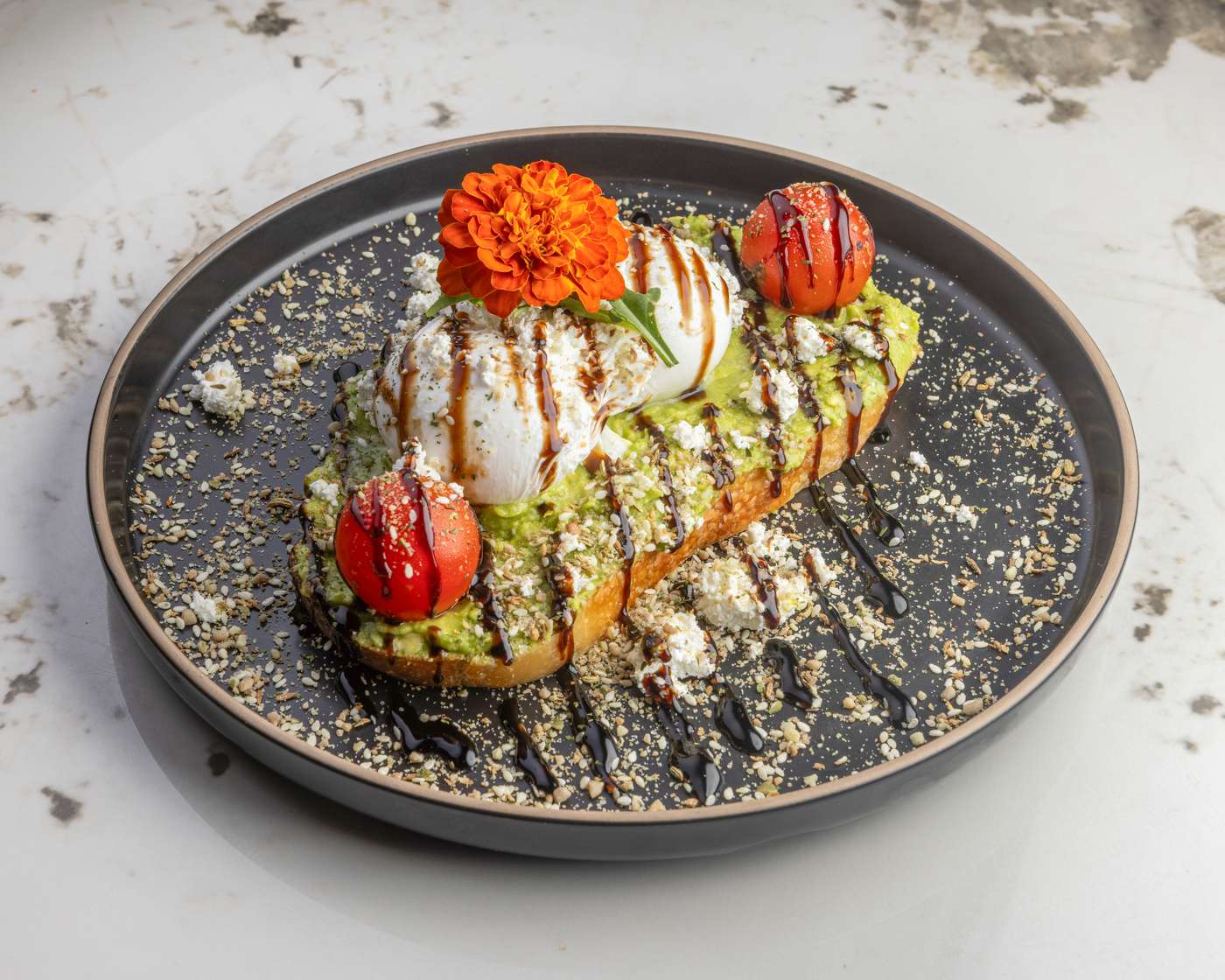 Avocado toast plated with an edible flower