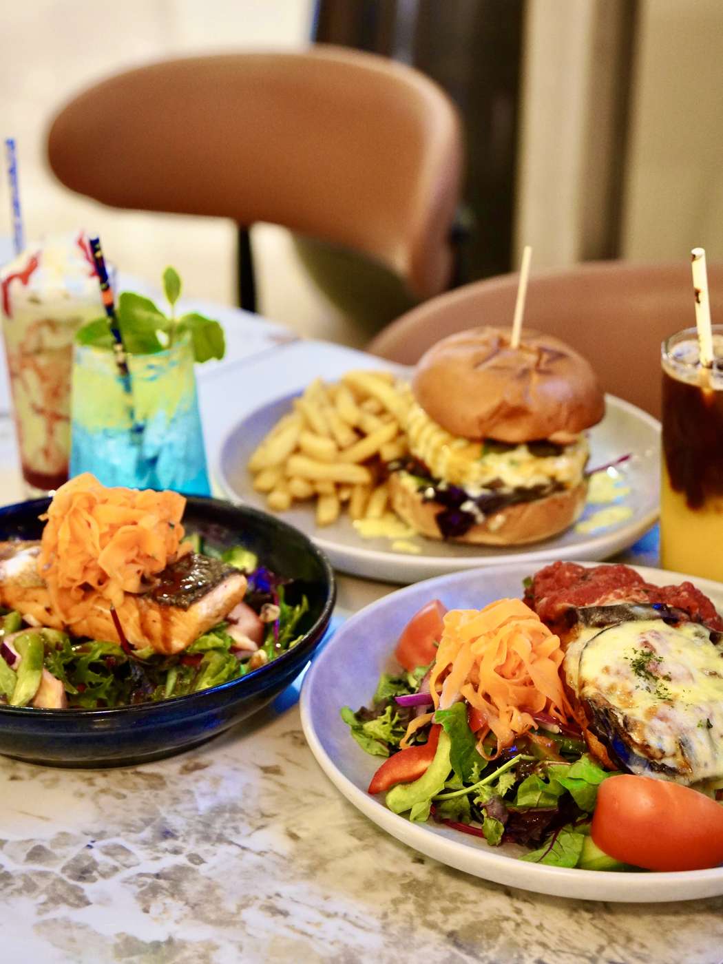 Lunch plates and drinks shared across a marble table