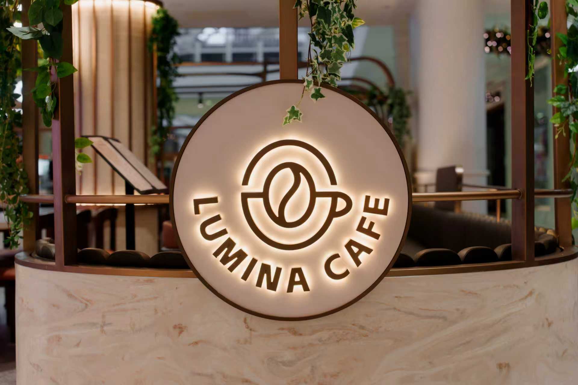 The illuminated Lumina Café shopfront sign