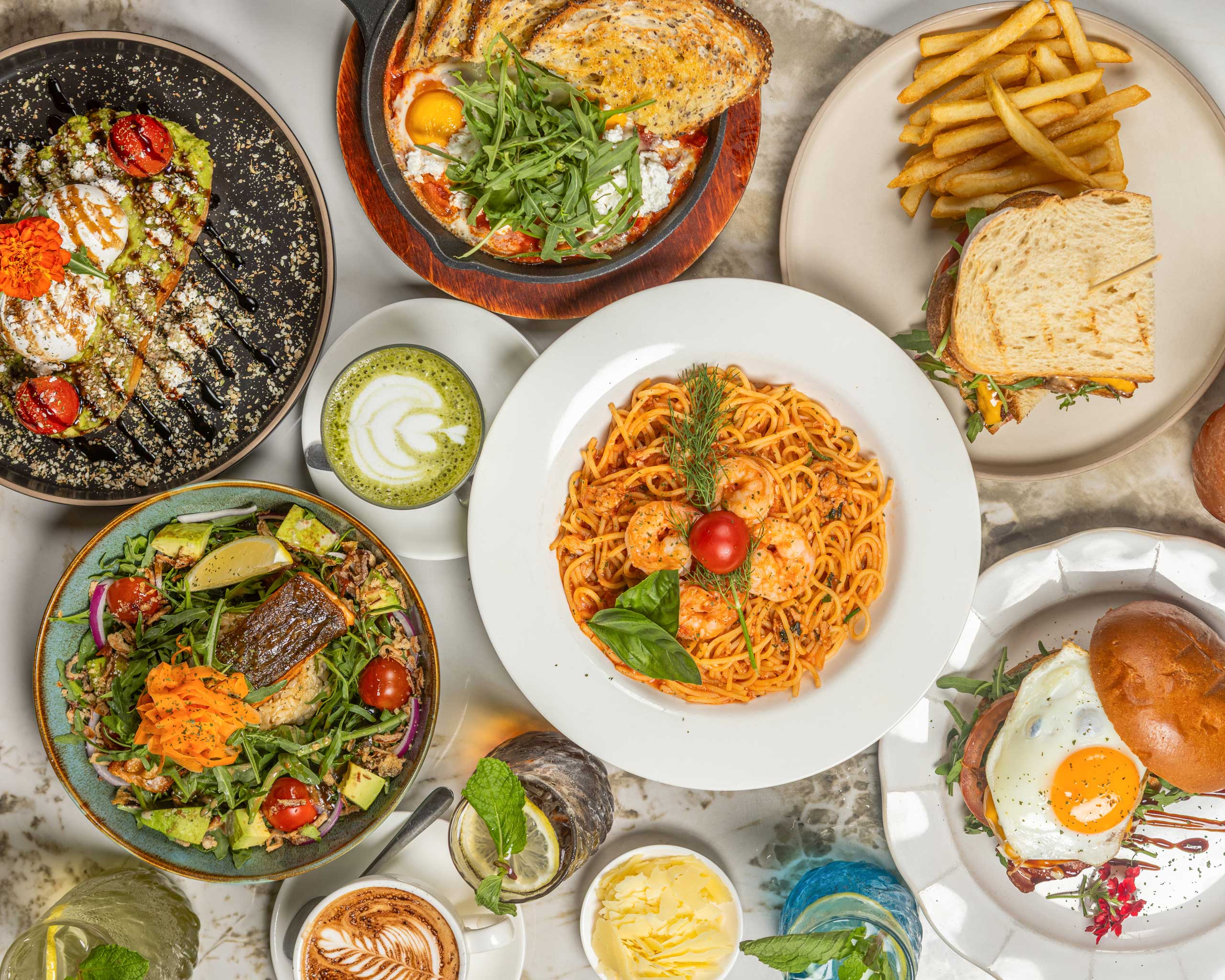 A table laid with brunch dishes and coffee at Lumina Café